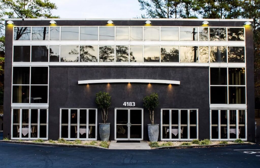 A building with a black exterior and windows.