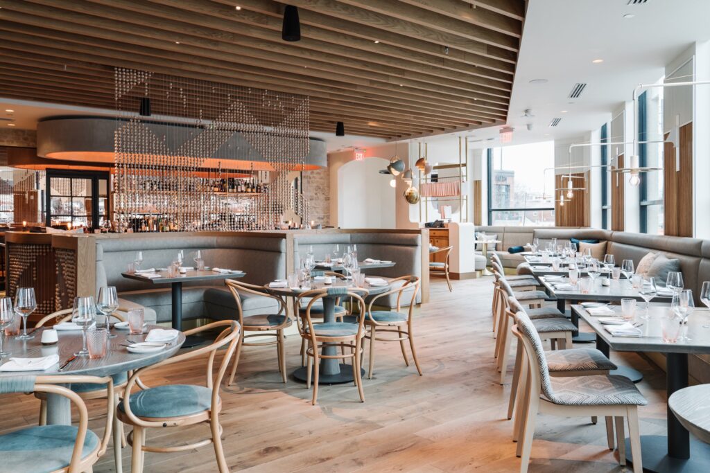 The interior of a restaurant with tables and chairs.