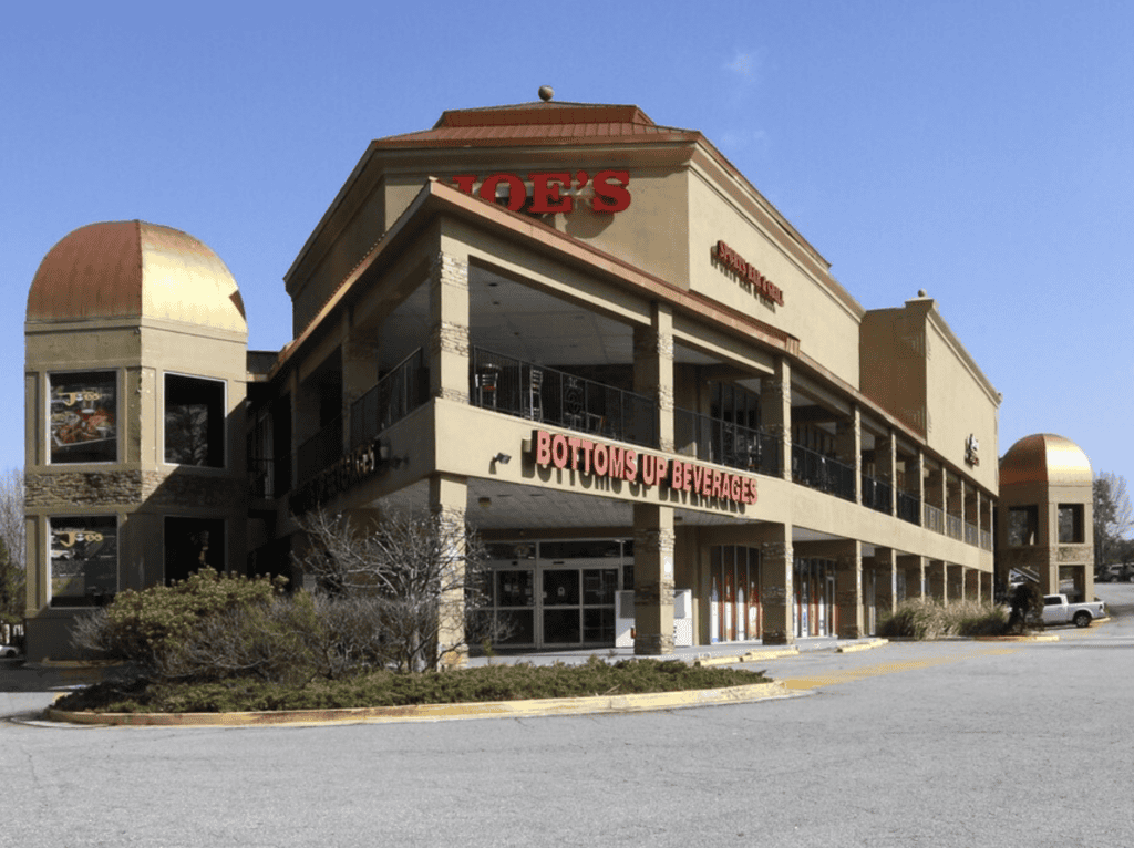 Atlanta restaurant real estate brokers office building with signage and outdoor seating.