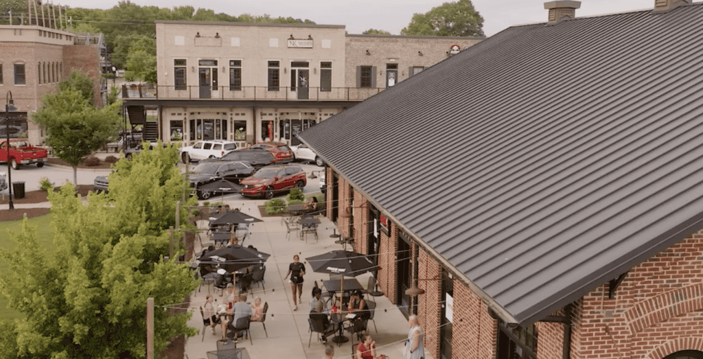 Outdoor dining area of Atlanta restaurant with patio seating and umbrellas.