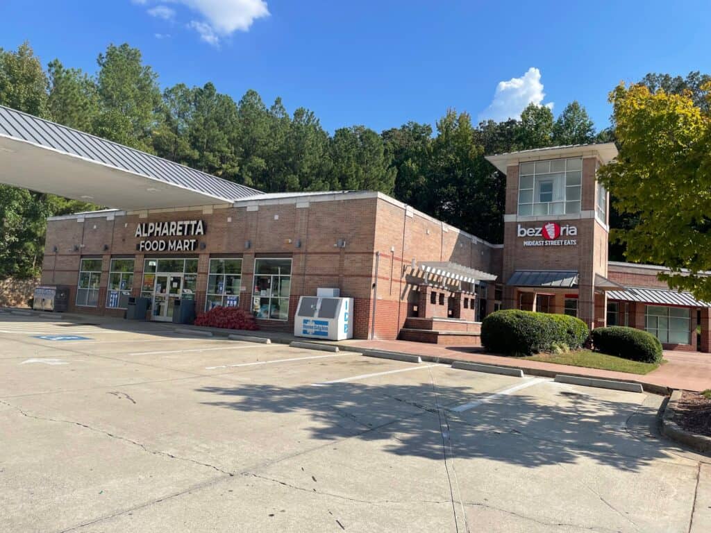 Commercial retail space for sale in Alpharetta, featuring Alpharetta Food Mart and Bezzria Restauran.