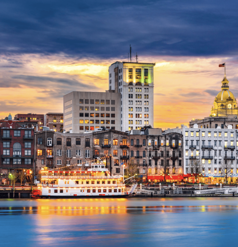 Atlanta restaurant real estate brokers skyline with historic buildings and waterfront views at sunse.