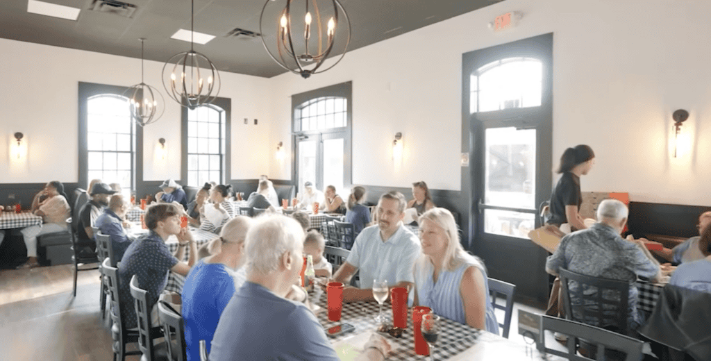 Atlanta restaurant interior with diners, natural light, and stylish decor.