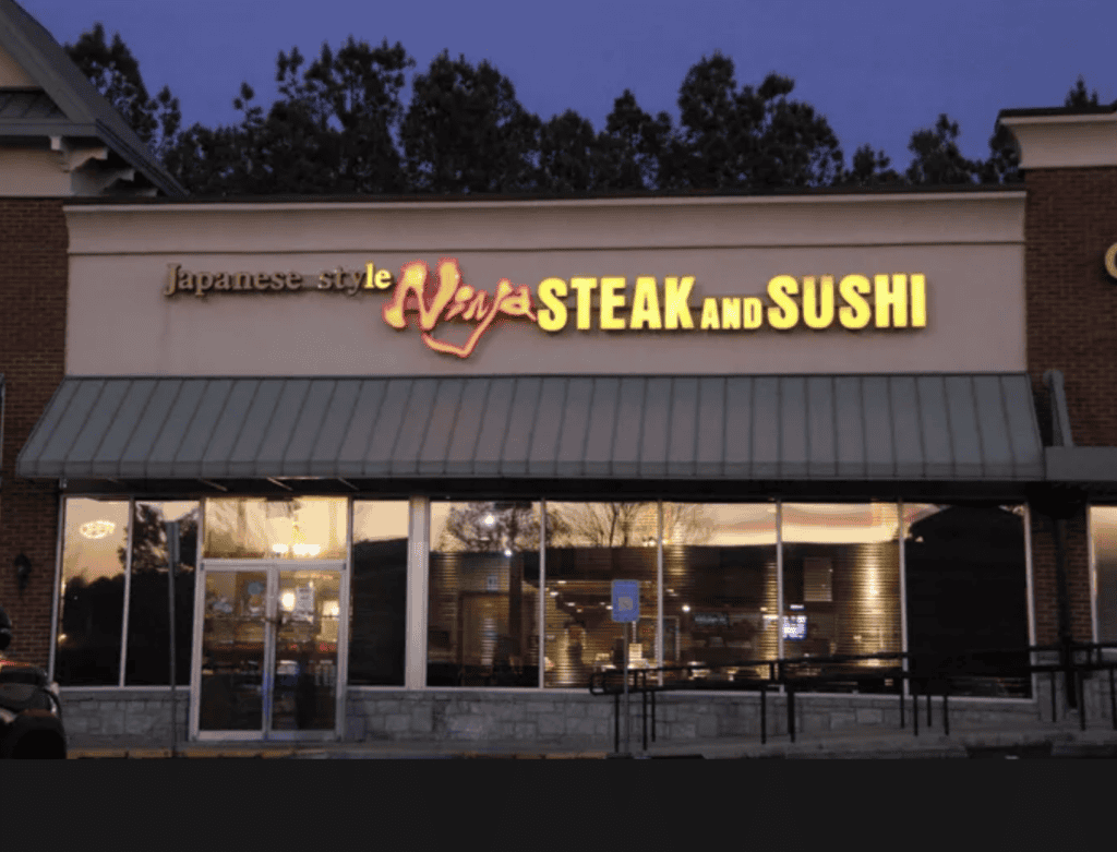 Ninja Steak and Sushi restaurant sign in Atlanta at dusk.