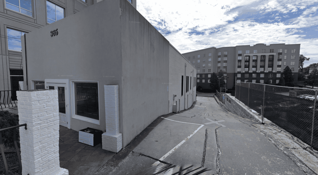 Atlanta restaurant real estate brokers office exterior with parking area.