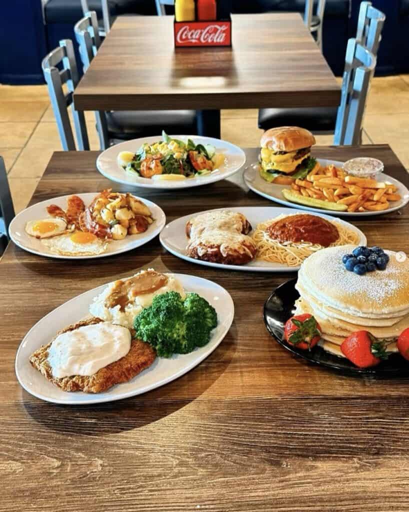 Delicious breakfast with pancakes, eggs, bacon, and fresh fruit at Atlanta restaurant.