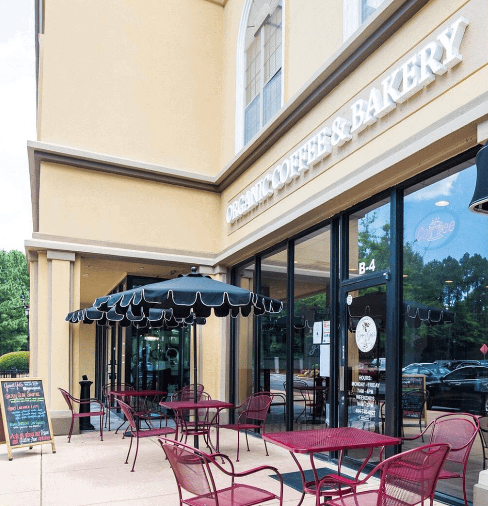 The outside of a bakery with tables and chairs, located in Buckhead.