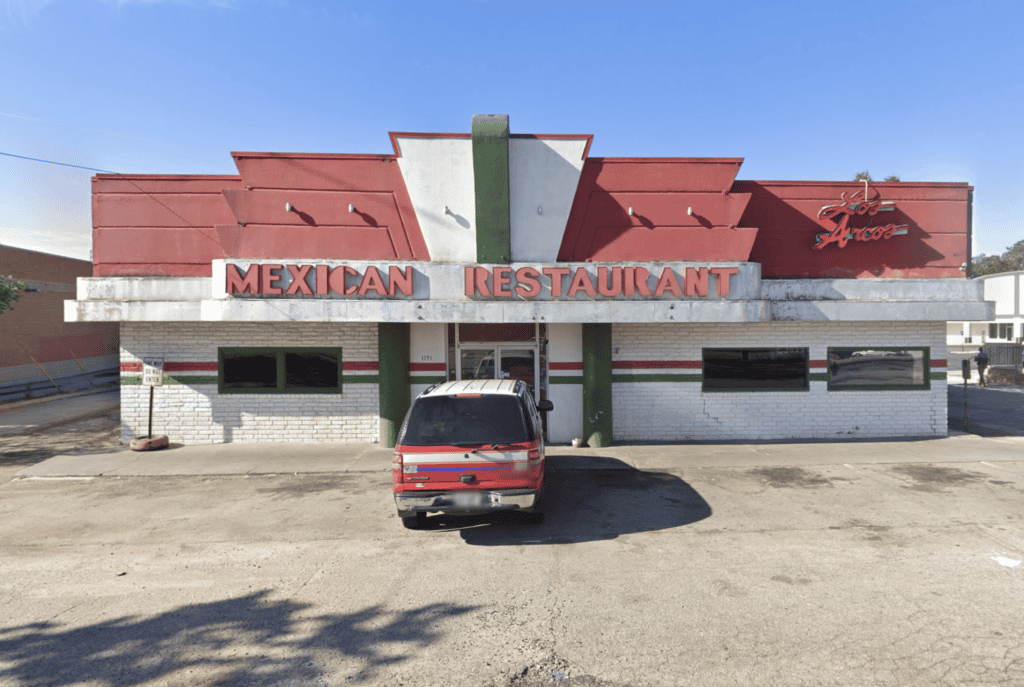 A freestanding restaurant with a red and white exterior, a faded "Mexican Restaurant" sign, and a parked van in front—perfect opportunity in Stone Mountain GA for those seeking a restaurant for sale.