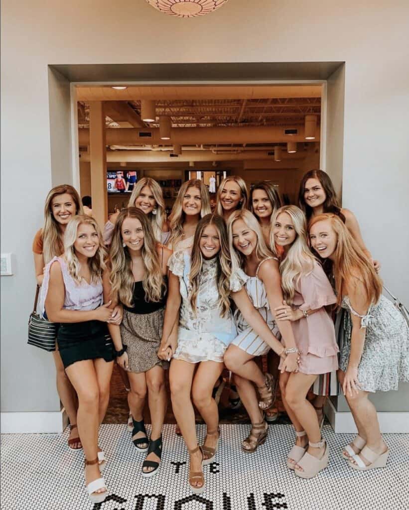 Group of women celebrating at restaurant opening in Atlanta, real estate brokers.