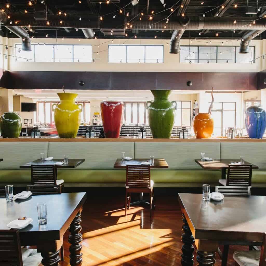 Interior of a modern Atlanta restaurant with colorful vases and dining tables.
