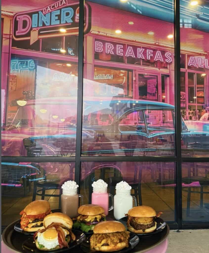 Atlanta restaurant with neon signs, vintage cars, and classic breakfast and diner food displays.